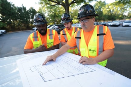 Century Fire employees reviewing drawings outside